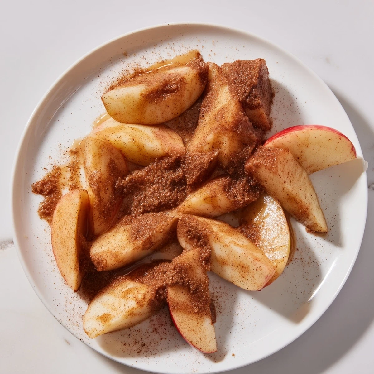 Golden brown Baked Apple Slices glistening with brown sugar, delicious served with vanilla ice cream.