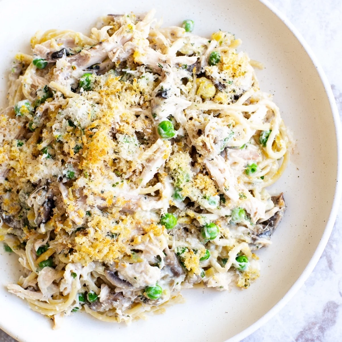 Golden-brown crust tops the creamy Turkey Tetrazzini Bake, promising a warm, comforting meal with tender turkey.