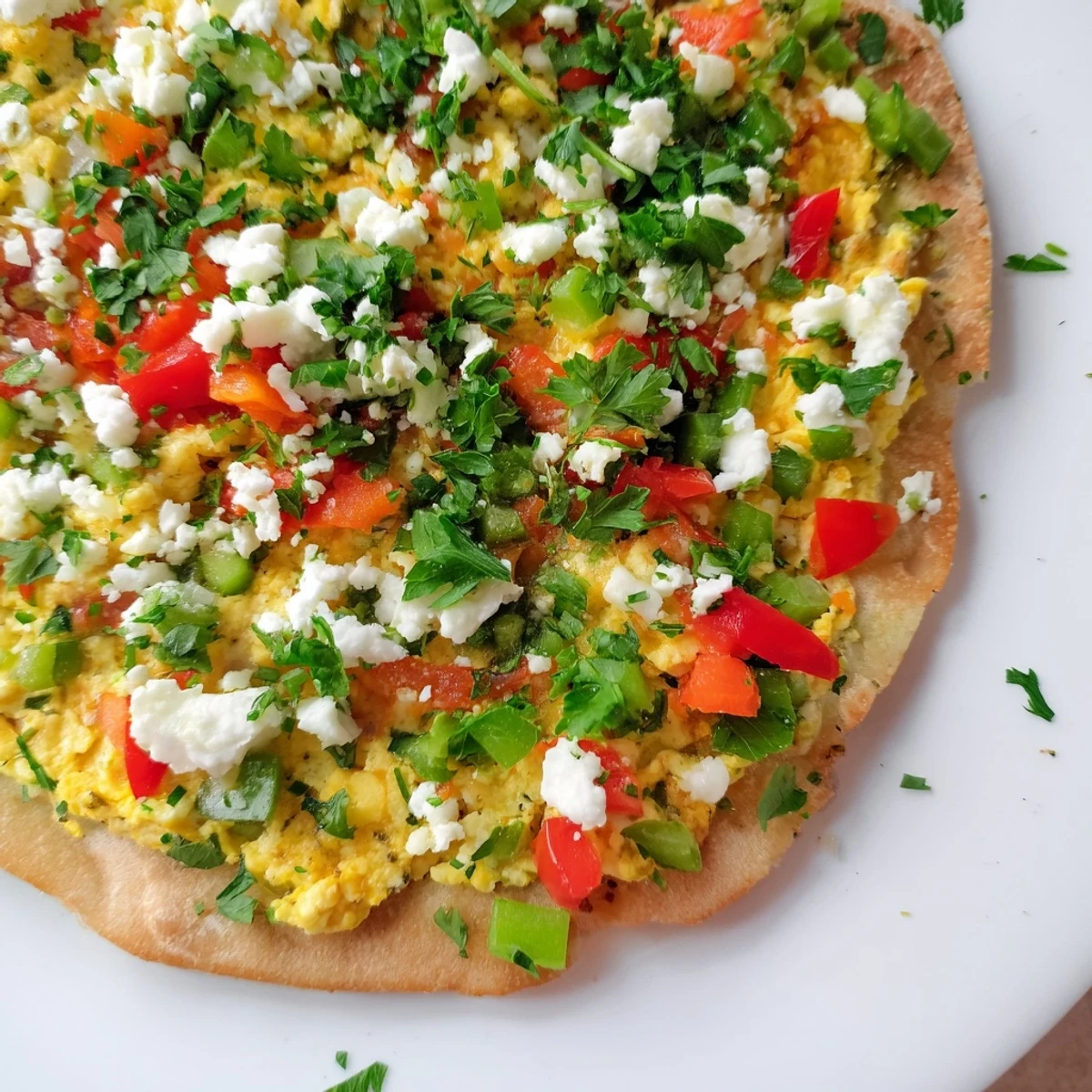 Crispy Turkish Menemen Eggs Pizza topped with creamy feta; imagine the vibrant colors.