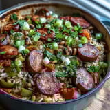 Steaming pot of Black-Eyed Pea Jambalaya featuring Andouille sausage, tomatoes, and cayenne spice