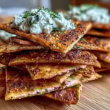 Oven-baked pita chips sprinkled with garlic and paprika, served with cool, refreshing tzatziki for dipping.  