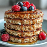 Fluffy High Fiber Protein Pancakes topped with fresh berries and yogurt.
