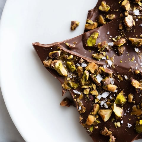 Golden, glistening Pistachio Salted Caramel Bark, studded with pistachios and sea salt crystals, awaiting a taste.