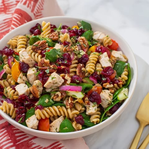 Bright pasta salad with cranberry vinaigrette: showcasing chicken, rotini, and a tangy dressing for lunch.