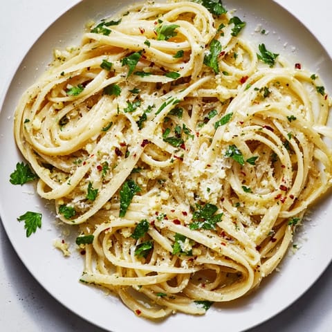 Silky garlic butter sauce coats the linguine, promising a delightful bite of Italian comfort food.