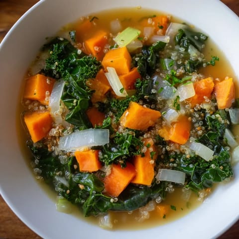Close-up of a flavorful Winter Veggie Soup brimming with colorful vegetables and fluffy quinoa.