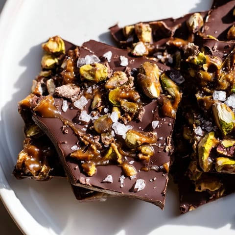 Homemade Pistachio Salted Caramel Bark: a delicious holiday dessert with chocolate, caramel, and crunchy nuts.