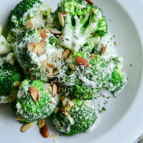 Blanched broccoli tossed with diced red onion and a rich, garlicky dressing, ready to serve as a fresh salad.