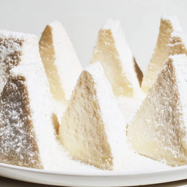 Elegant appetizer, The Snowcapped Range, features chilled Brie arranged like mountains with Parmesan dusting.