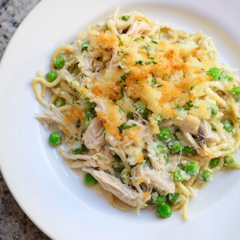 Hot, freshly baked Turkey Tetrazzini, a pasta bake showcasing savory turkey with a creamy sauce and golden topping.