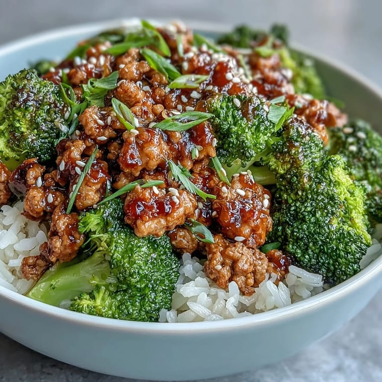 Steam rises from a freshly prepared Sweet and Spicy Turkey Broccoli Bowl, showcasing tender turkey and bright green broccoli florets.