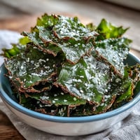 Crispy seaweed snack chips seasoned with sesame and sea salt, perfect for dipping.